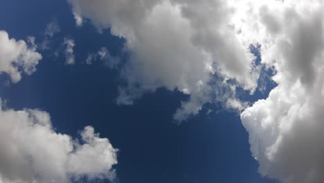 4k. timelapse of clouds in a blue sky. the sun's rays pass through clouds