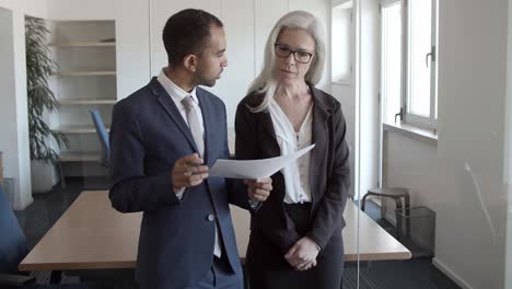 female professional showing report to boss