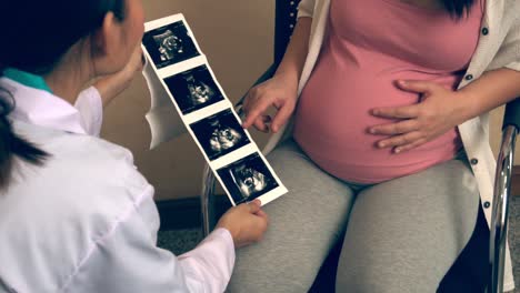 pregnant woman and gynecologist doctor at hospital