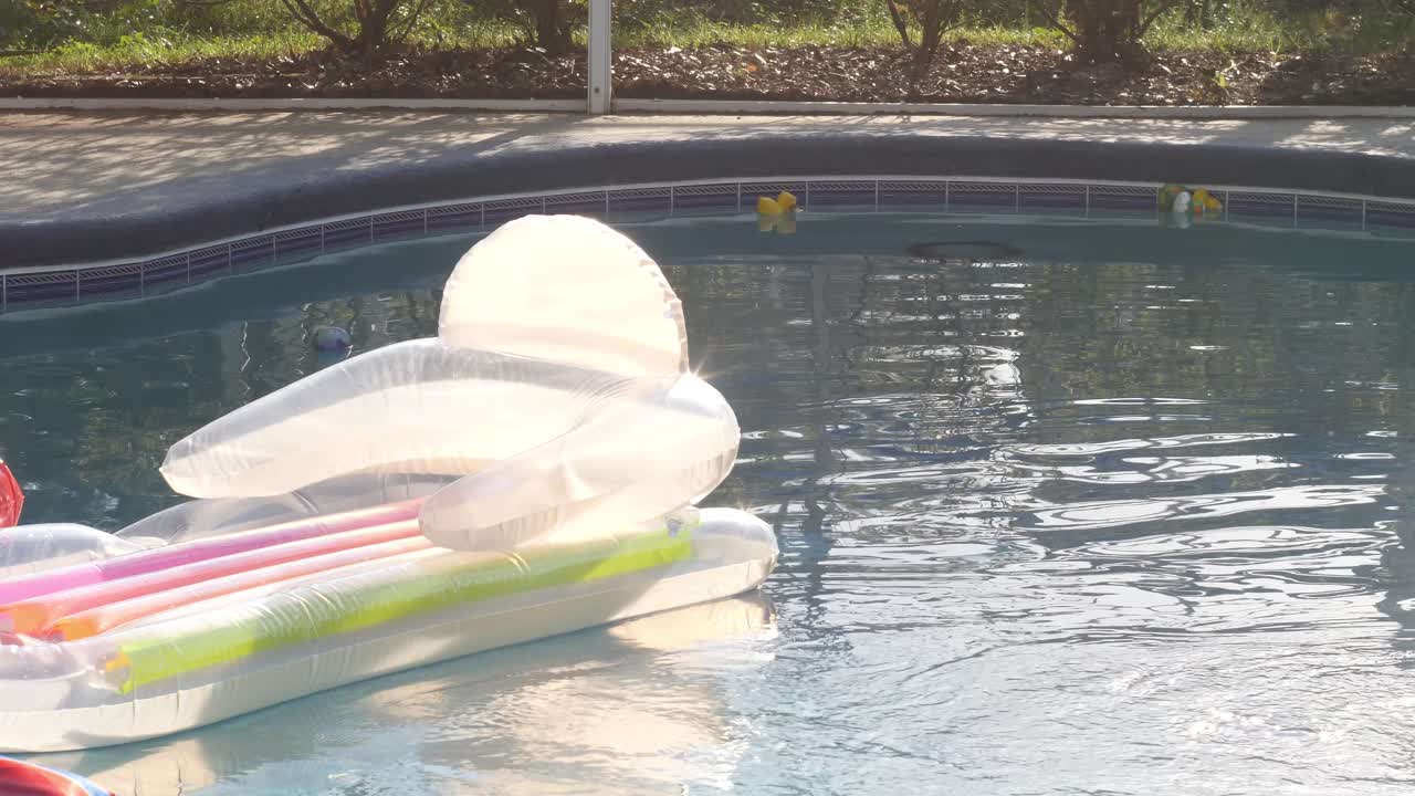A Pool Float Chair Reflects Soft Sunlight in Slow Motion