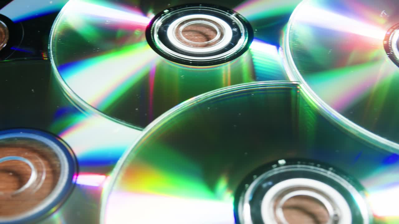 CD disks on black background close-up. Old vintage disks for DVD player or computer. Music recorder, playing retro computer games.