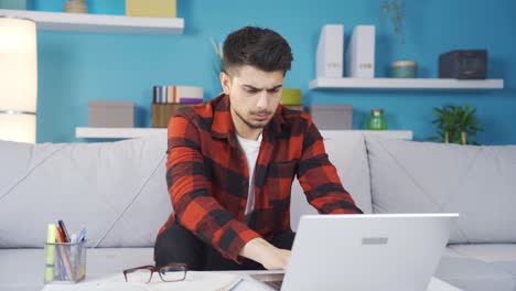 Stressed-and-thoughtful-young-man-working-on-laptop.