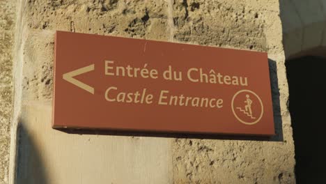 signage indicating direction to castle entrance