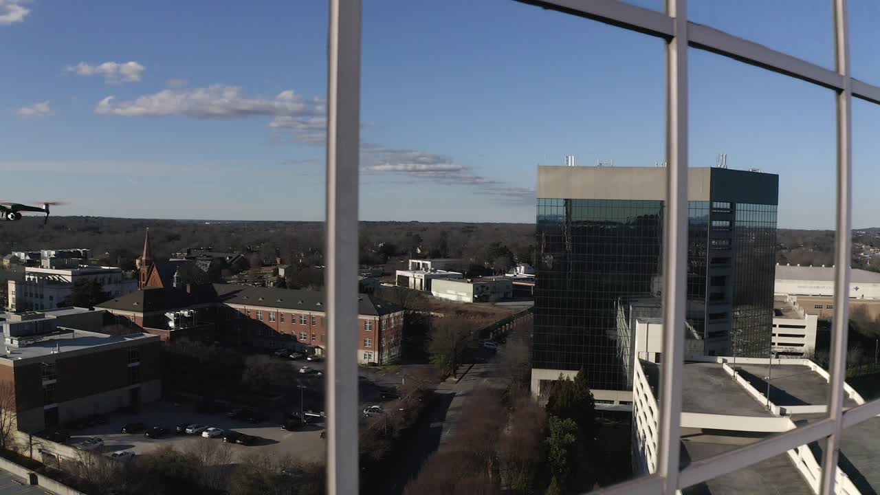 toma aérea del dron dji mavic chocando contra una ventana de vidrio en un entorno urbano