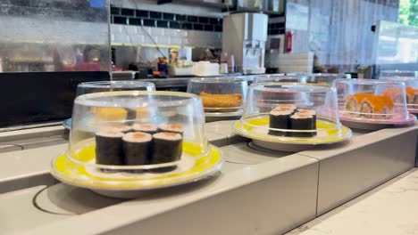 sushi plates moving on a conveyor belt