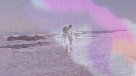 walking on beach, couple surrounded by colorful animation effects in background
