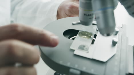 scientist using microscope