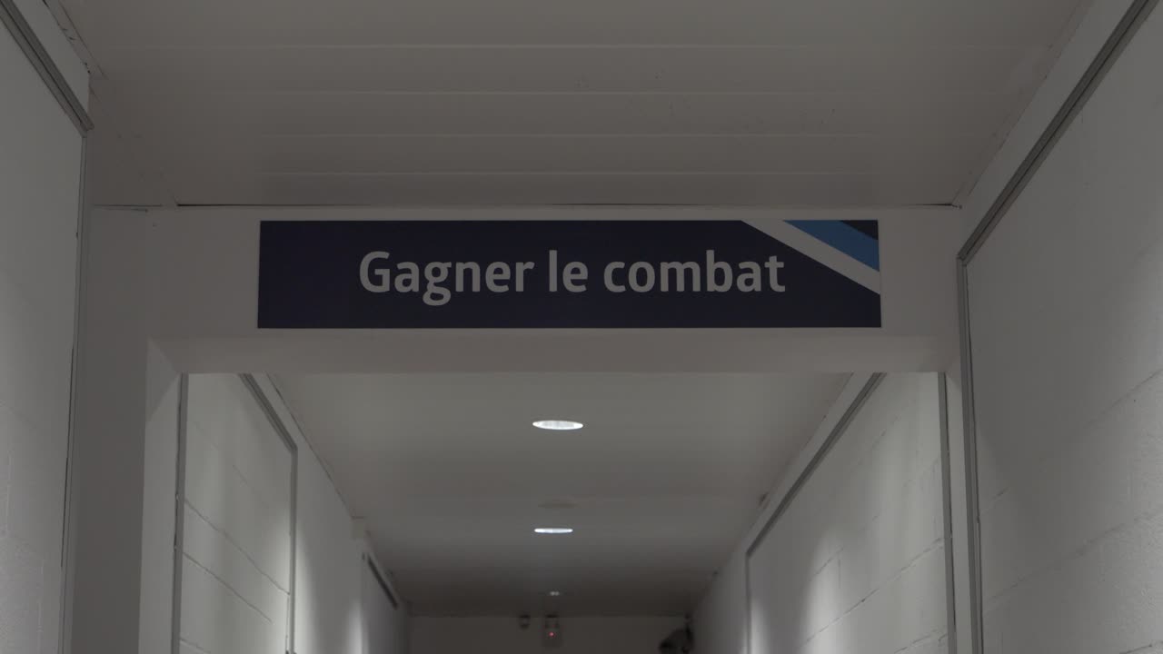 Win the Battle: Inscription in the Locker Room Hallway of a Football-Rugby Stadium