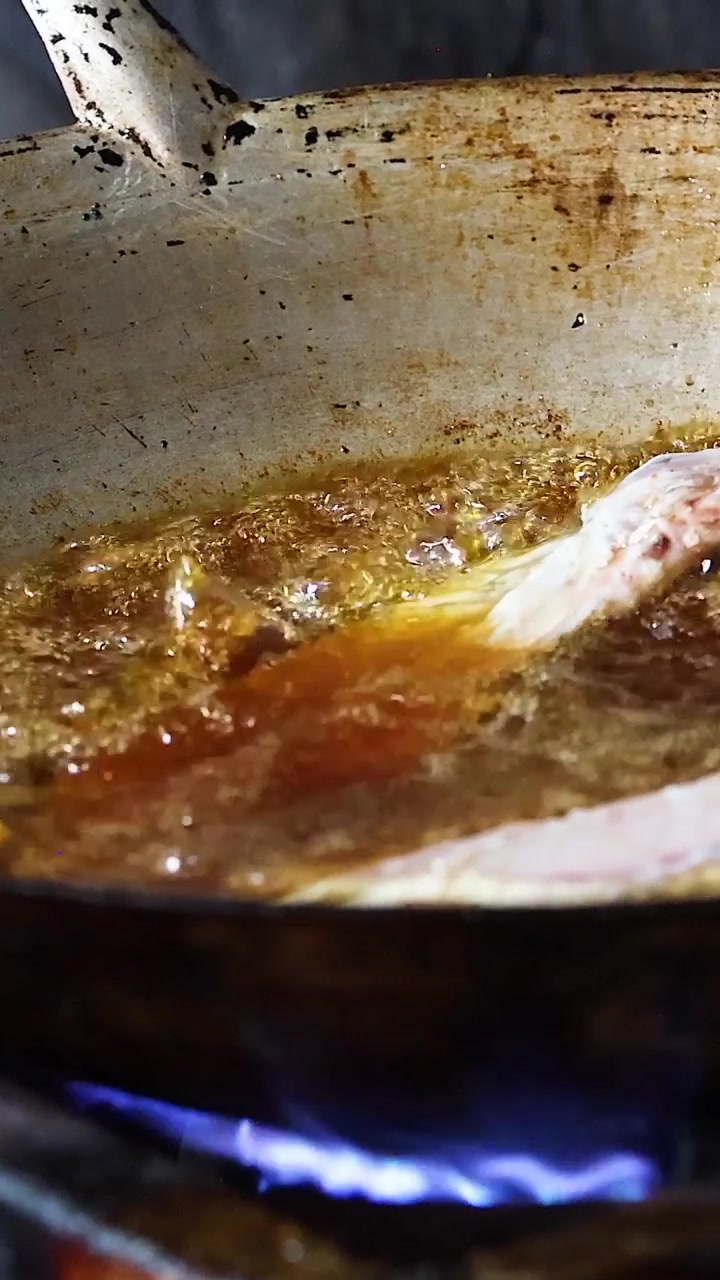 Sequence of frying fish in hot oil on stove