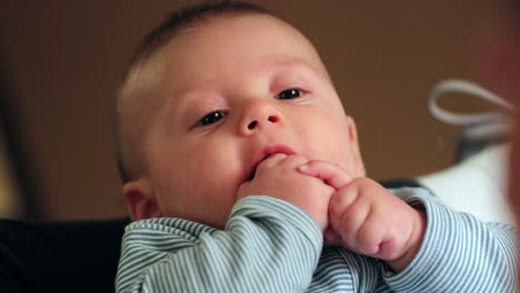 infant baby with hand in mouth