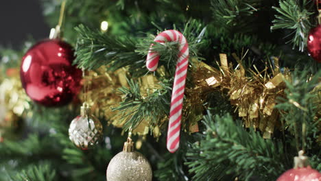 video of christmas tree with caandy cane, baubles decorations and copy space