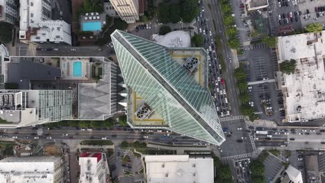 High-angle-drone-shot-of-skyscraper-and-busy-street-of-Buckhead,-Air-conditioner-exhaust-vents-at-building-rooftop,-Atlanta,-Georgia,-USA