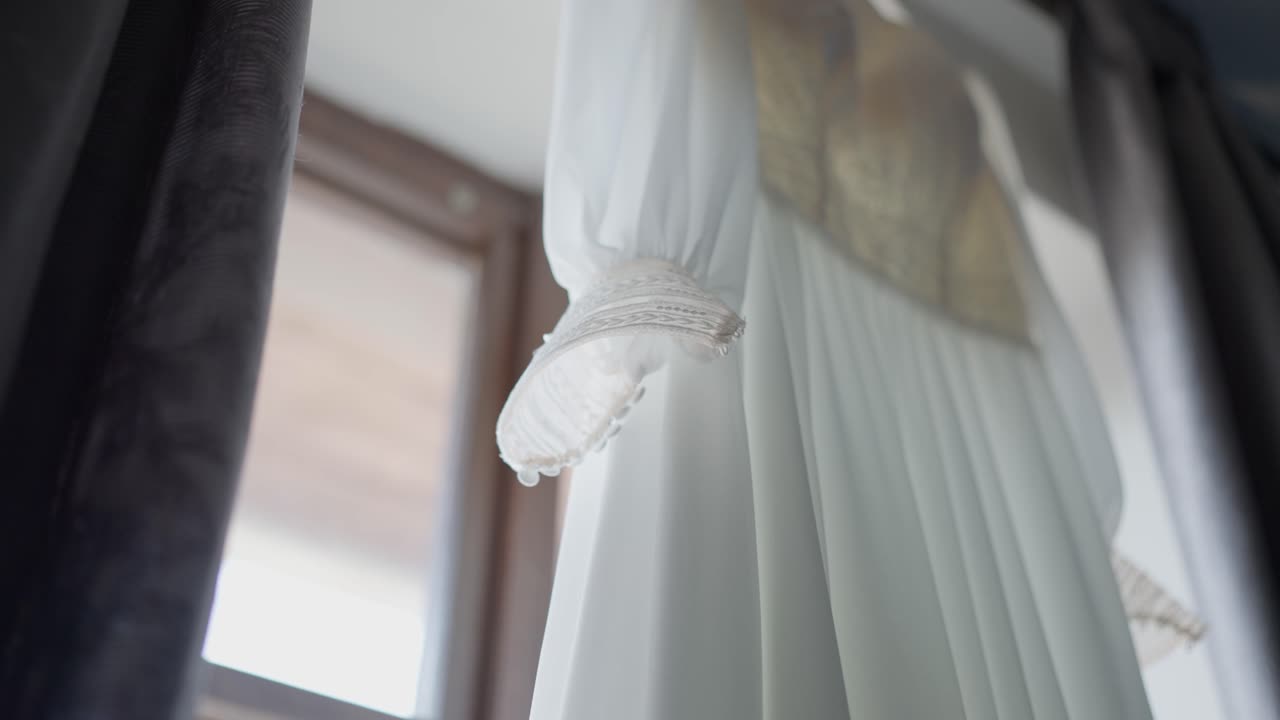 Detail of a white wedding dress for the ceremony. Preparation of the bride and for marriage