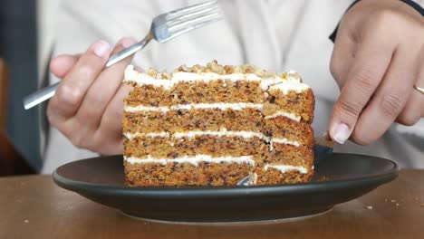 woman eating a slice of carrot cake