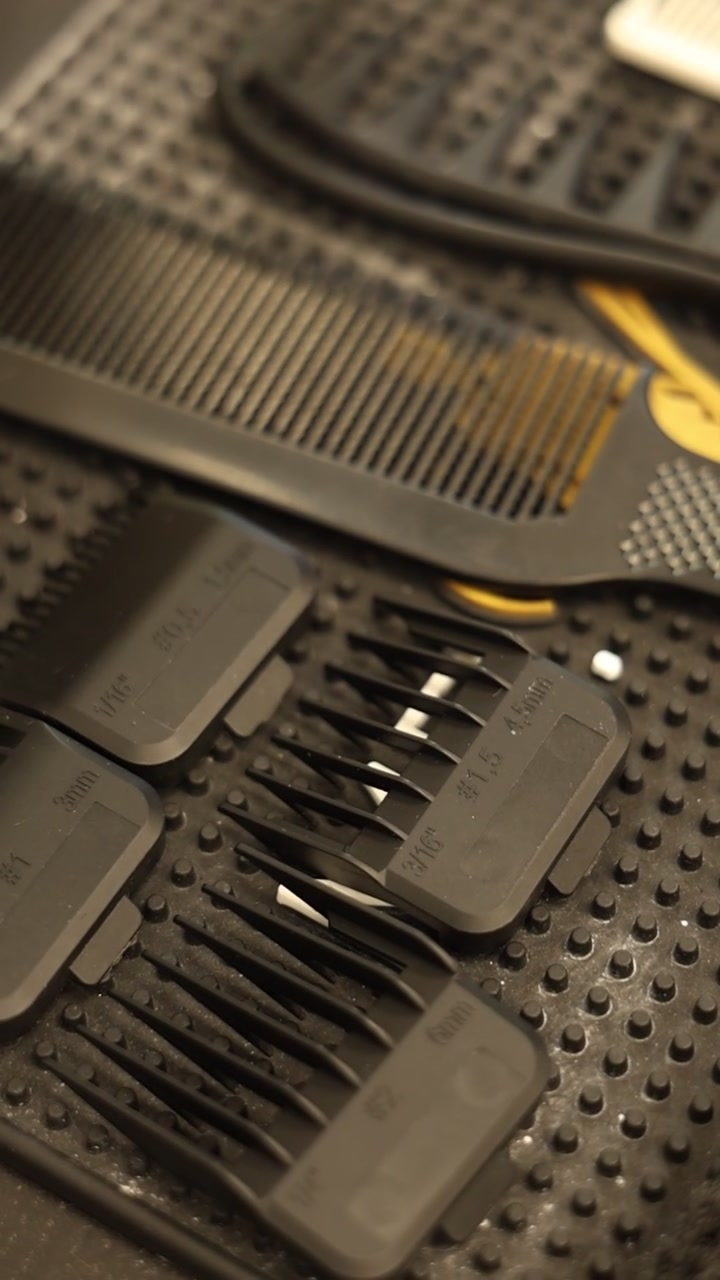 Barber Hair Clipper Guards and Comb on a Rubber Mat