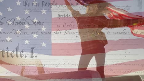 young african american women holding us flag with us flag waving and constitution foreground