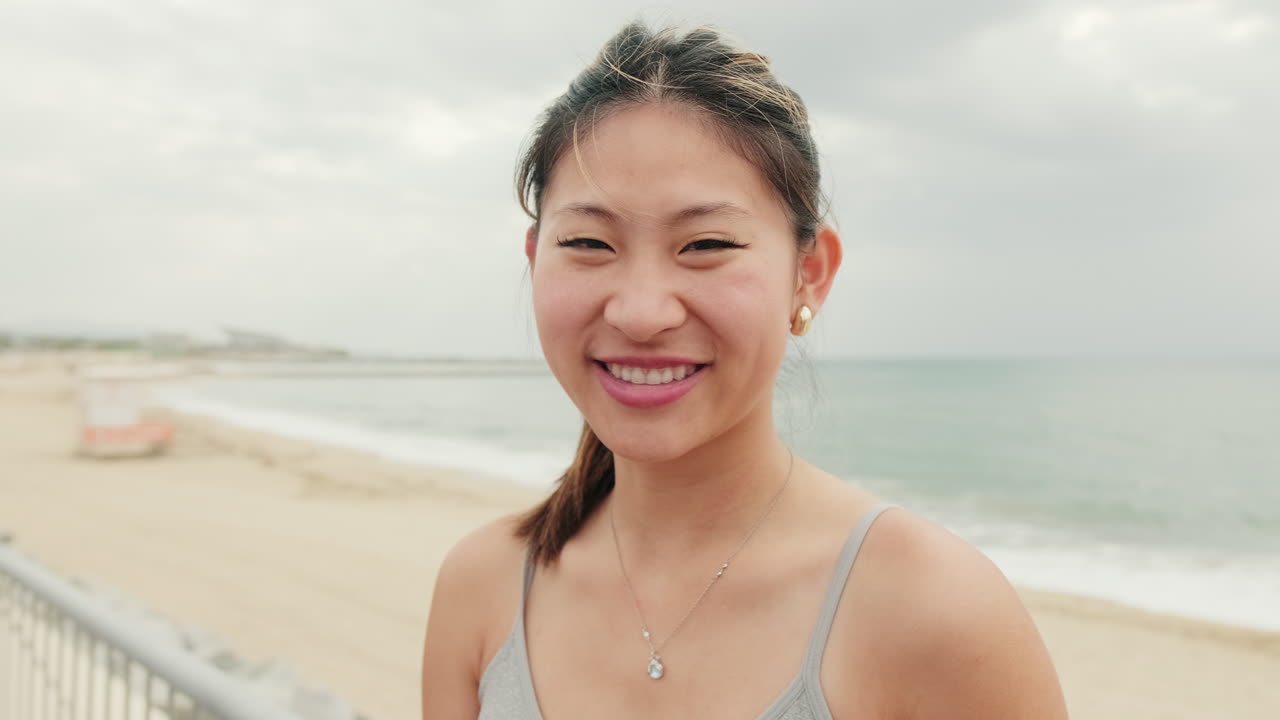Smiling Asian Woman on Beach