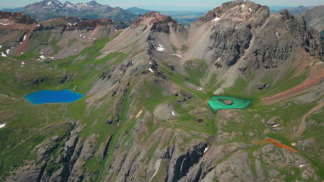 aerial drone cinematic high altitude ice lake basin island lake trail unreal blue water hike silverton ouray red mountain pass colorado dreamy heavenly rocky mountain scene summer peaks forward reveal