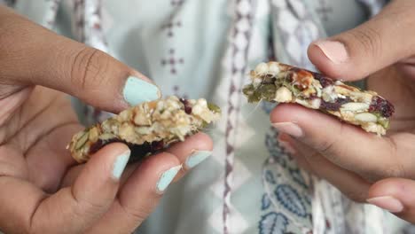 close up of a granola bar being broken in half