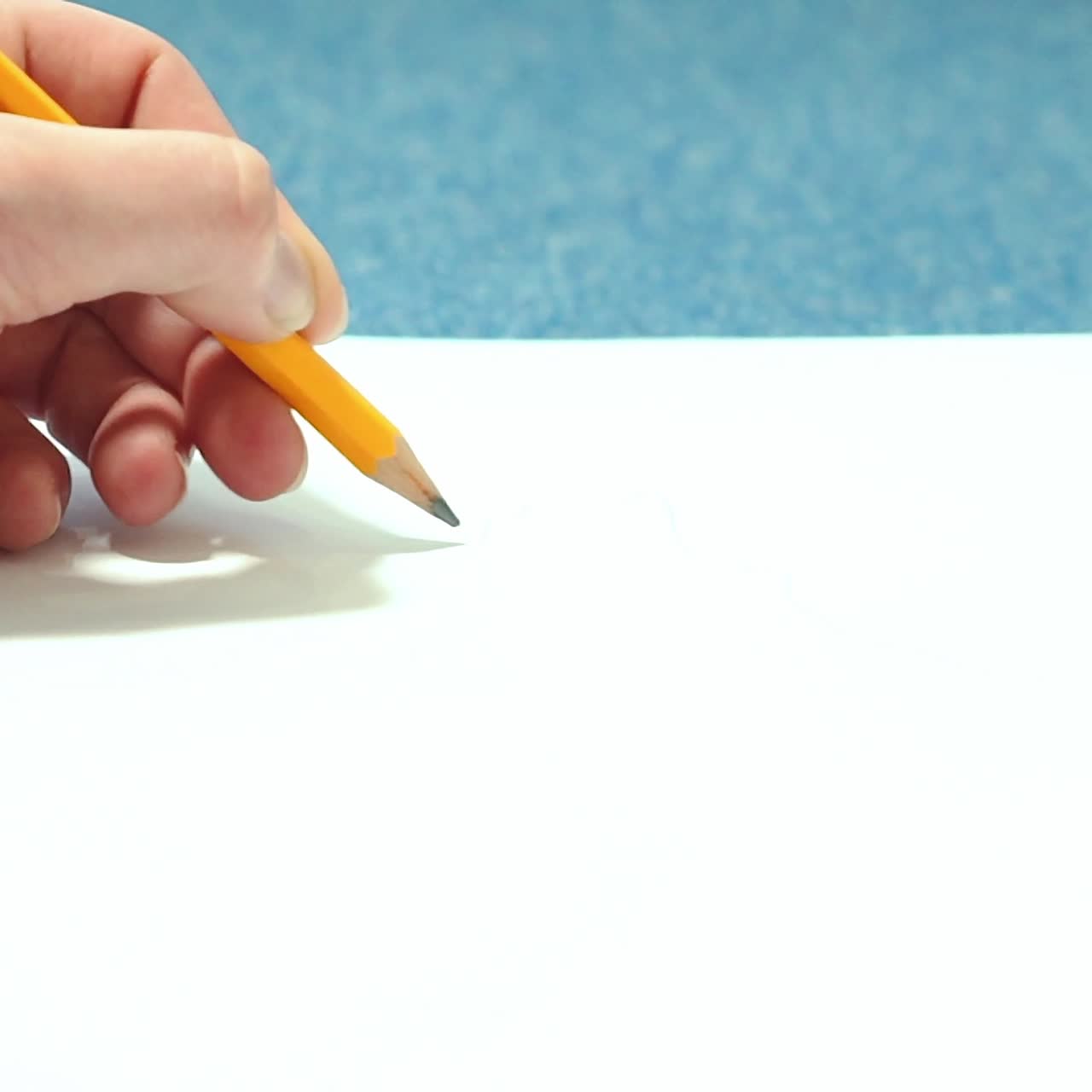 Girl doing pencil sketches on paper. Young woman learns to draw.