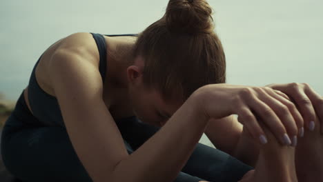 Attractive-girl-sitting-yoga-pose-on-beach-close-up.-Woman-stretching-outdoors.