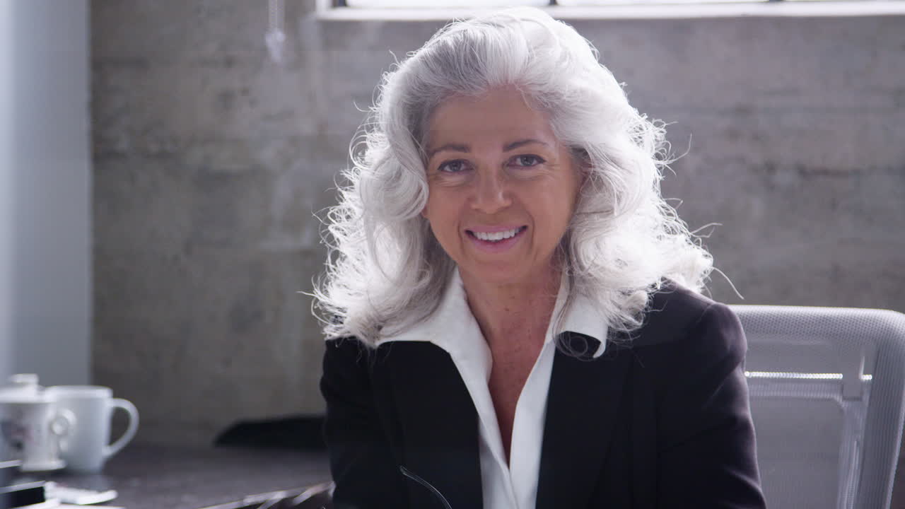 Senior white businesswoman smiling to camera