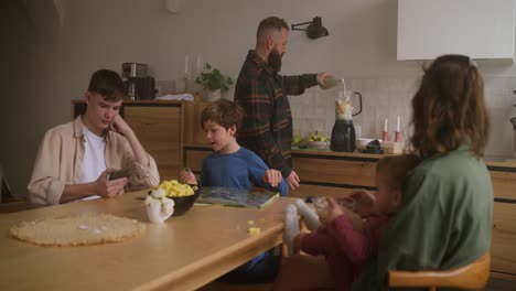 family preparing and enjoying a meal at home