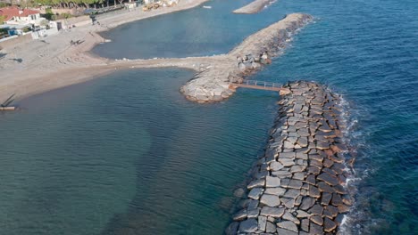 beaches of quaint cervo protected by mole breakwaters, italian riviera