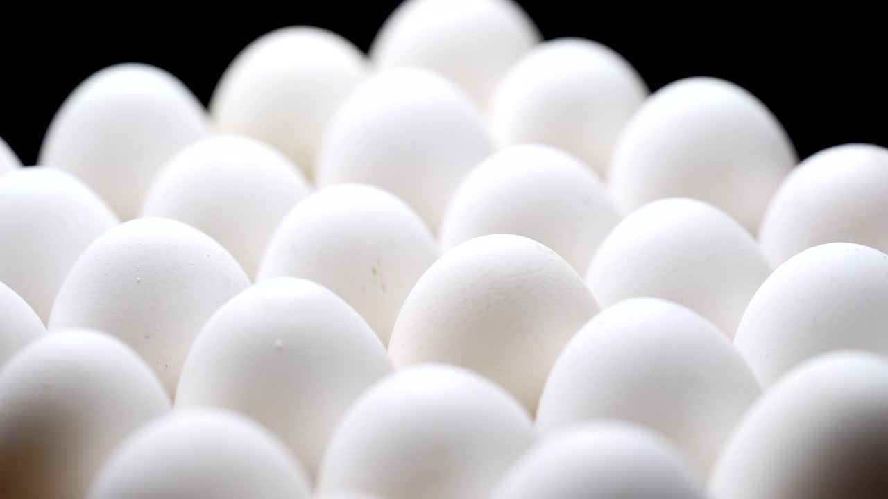 Close-up of packed chicken eggs. White eggs in carton box.