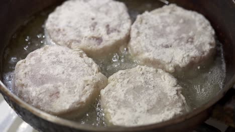 сooking homemade fried fish burger patty. frying fish patties with hot oil