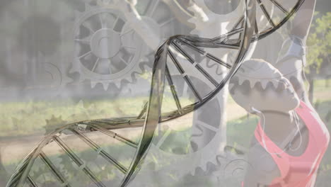 animation of dna strand and cogs over african american woman exercising