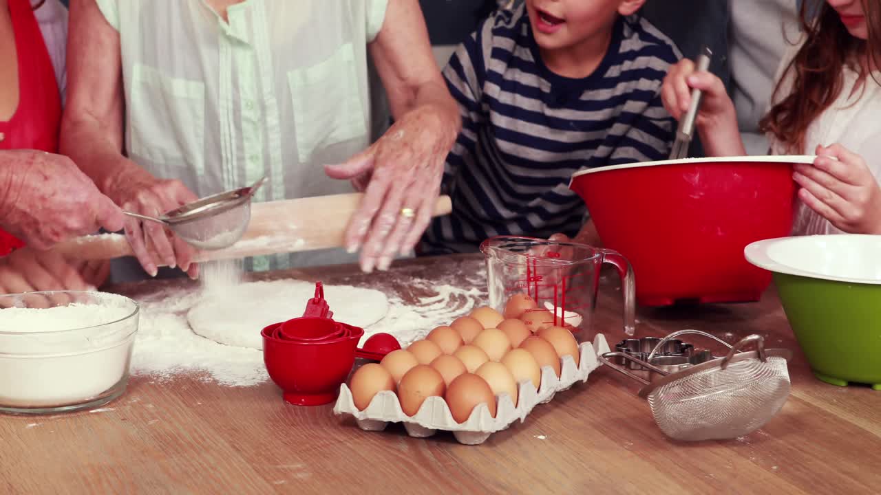 Happy family cooking biscuits together