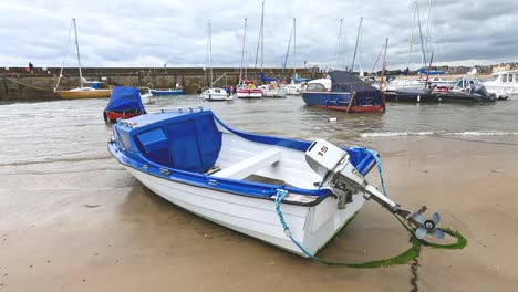 boat on sandy shore with other boats nearby