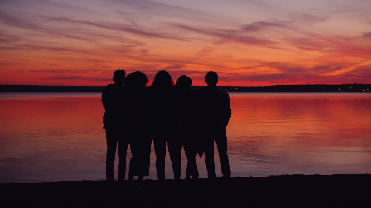 Friends Silhouetted at Sunset on the Beach