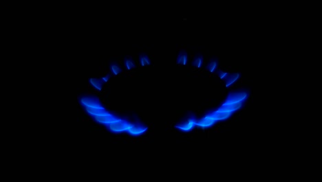 turn on the gas stove in the kitchen, blue gas flame. close up, 4k video.