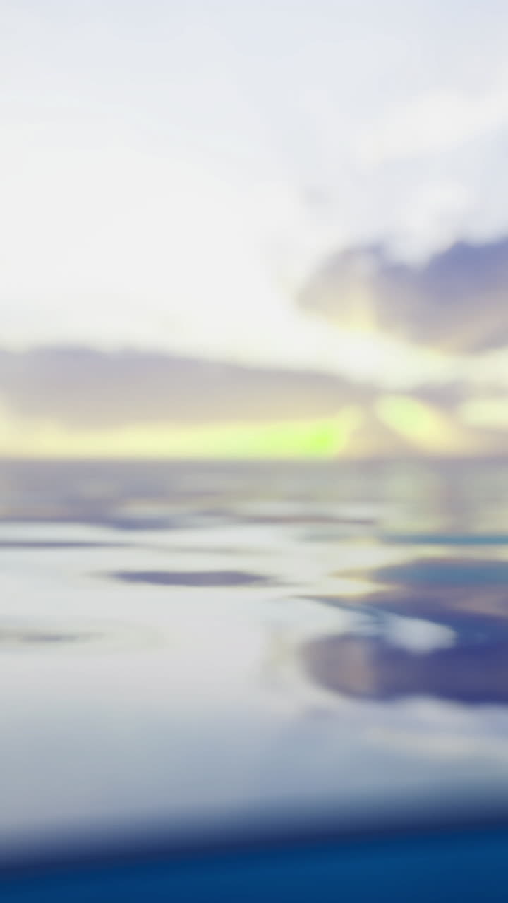 Sunset over serene ocean water with gentle waves