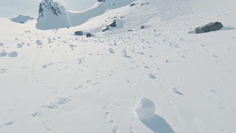 Snow-rolls-left-from-avalanche-in-majestic-landscape-of-Norway,-aerial-drone-view
