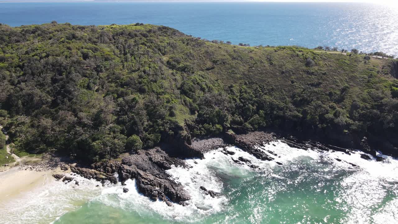 Aerial drone over Noosa beach and park, showcasing vibrant blue ocean waters