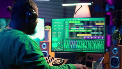 young musician twisting knobs and mixing tunes with a console