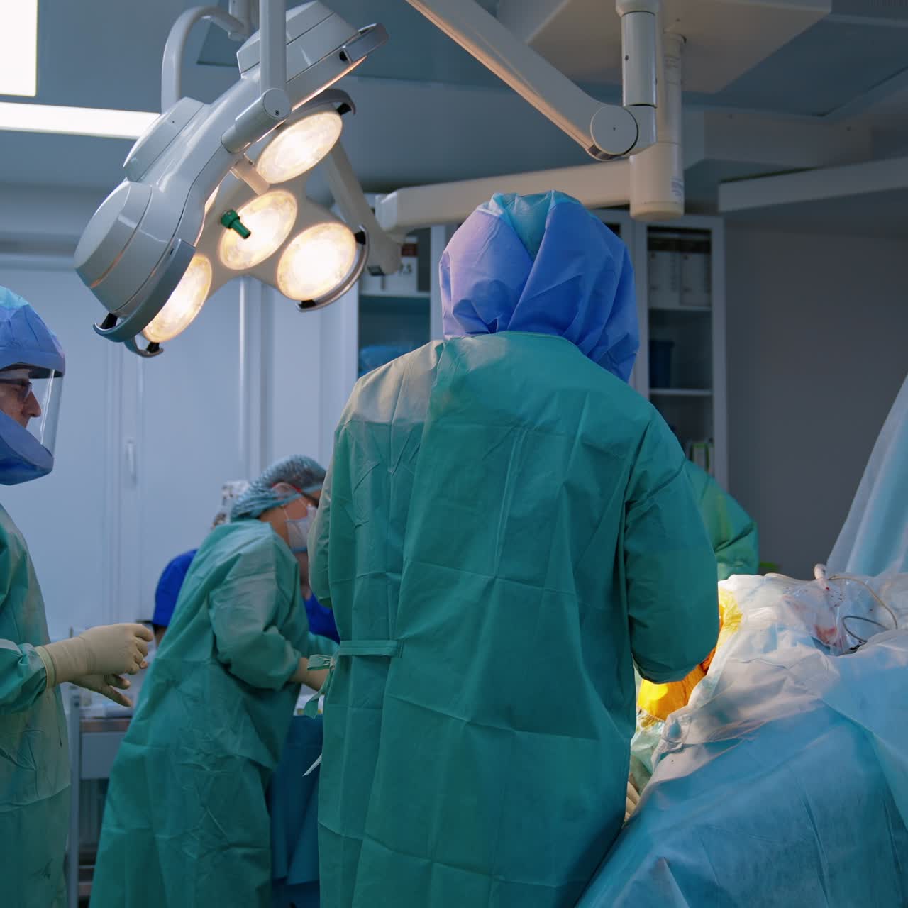 Orthopedic surgery on a knee. Doctor covers patient's leg with iodine. Orthopedic surgery in modern hospital