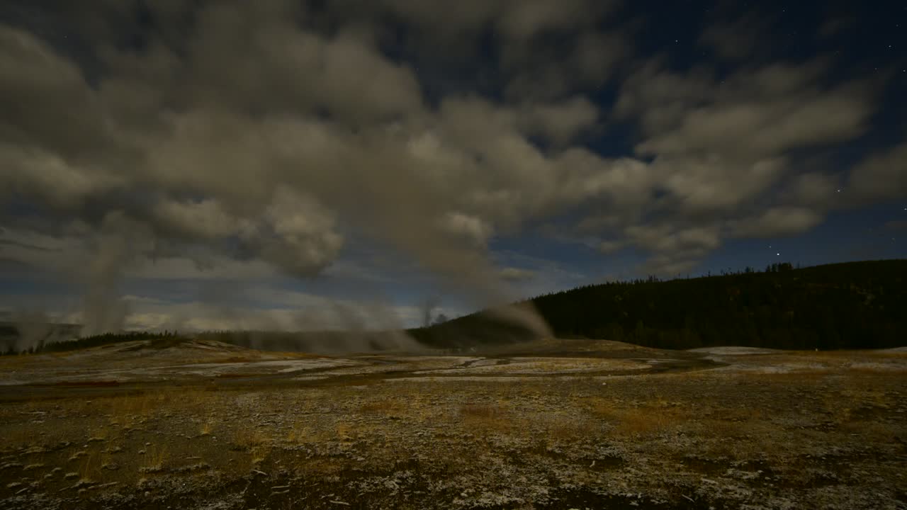 Time lapse of Old Faithful in Yellowstone National Park on a windy day at dusk