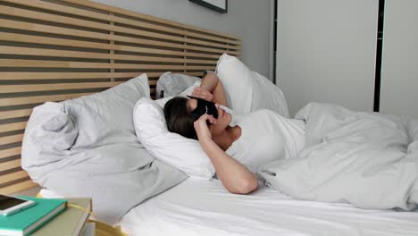 woman lying down in her comfortable bed