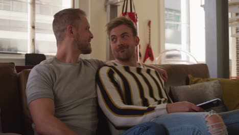 Caucasian-male-couple-in-social-distancing-in-their-sofa-at-home