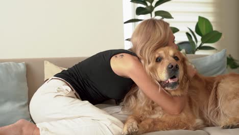 happy smiling woman is hugging with affection her lovely labrador retriever