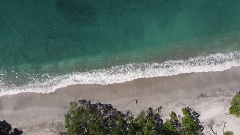 Vista-Aérea-De-Una-Niña-Relajándose-En-Una-Playa-Paradisíaca-En-Costa-Rica