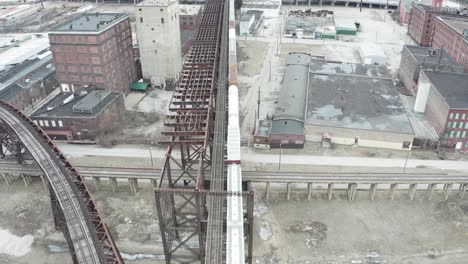 flyover above old rusted train bridge in rundown area of st