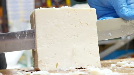 cutting a block of feta cheese