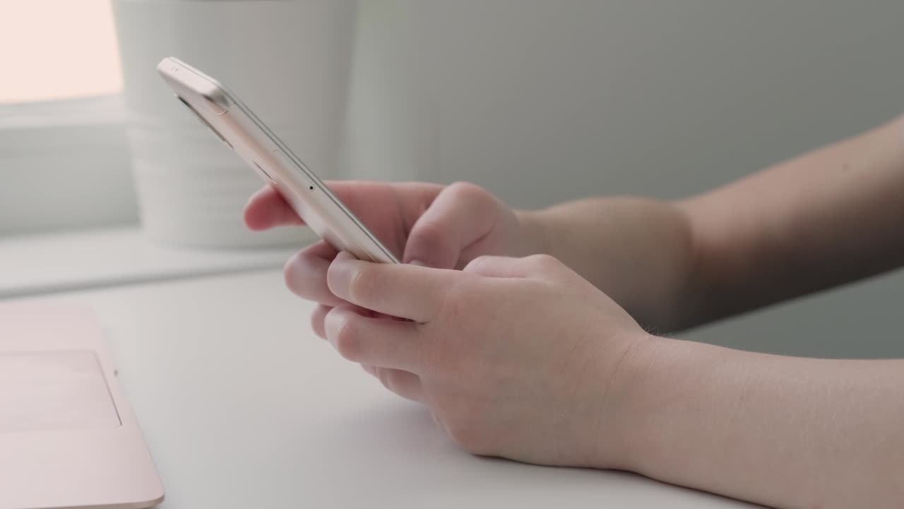 Cellphone in hands of child close-up. Communication in social networks, child-blogger