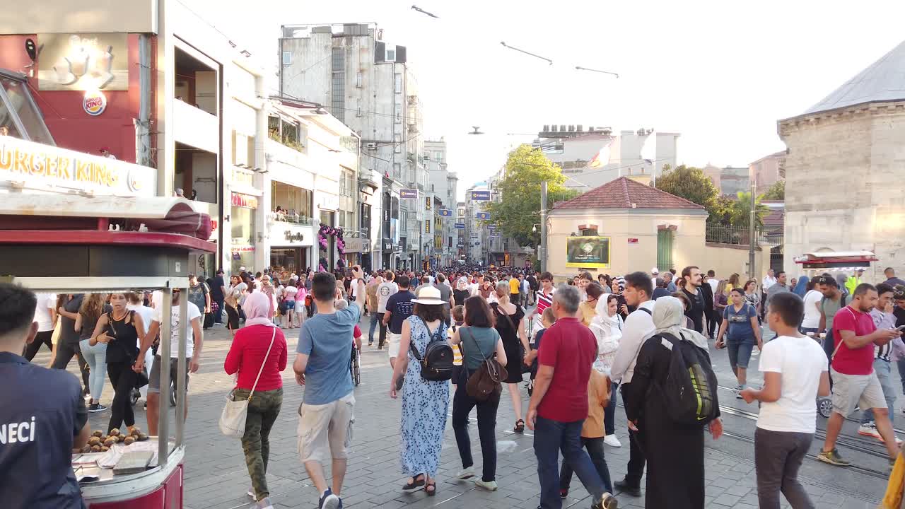 Locals and tourists walk and explore at popular Taksim Square in Beyoglu,Turkey.25 July 2019