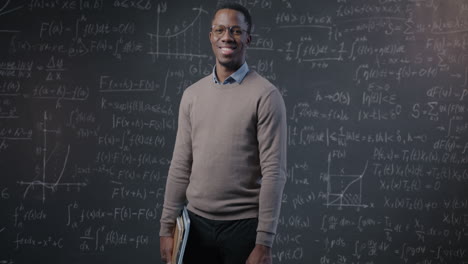 teacher in front of a chalkboard with mathematical equations